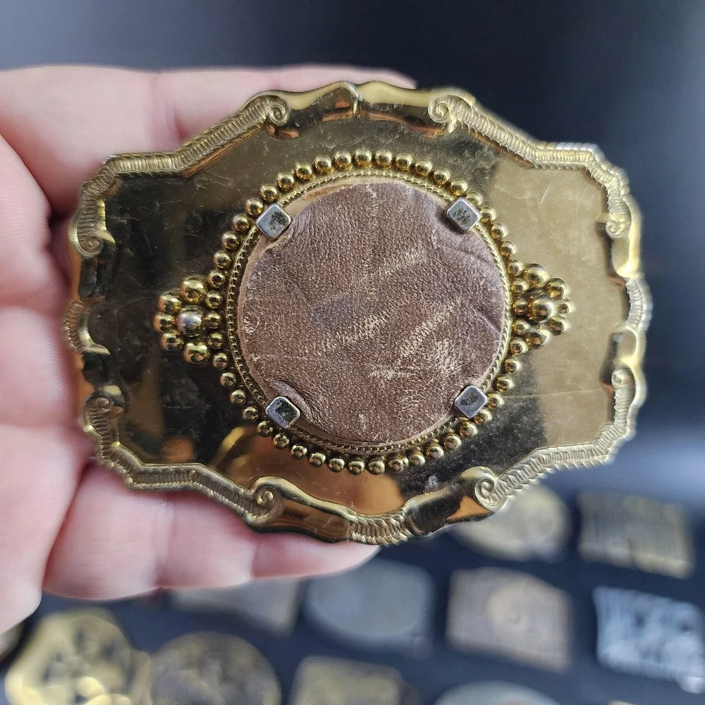 Vintage Metal Belt Buckle, Brass, Round Token Holder, holding a piece of leather